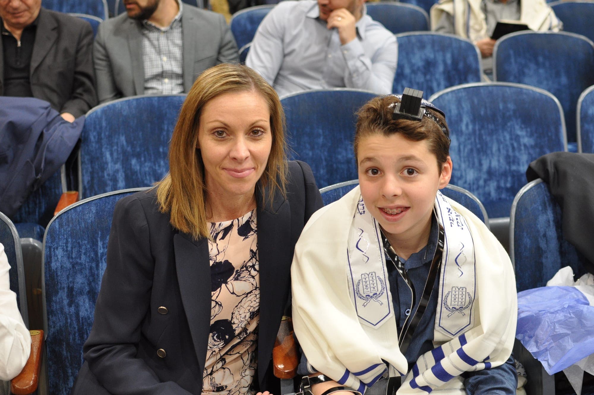 Mother and son sitting together at his bar mitzvah