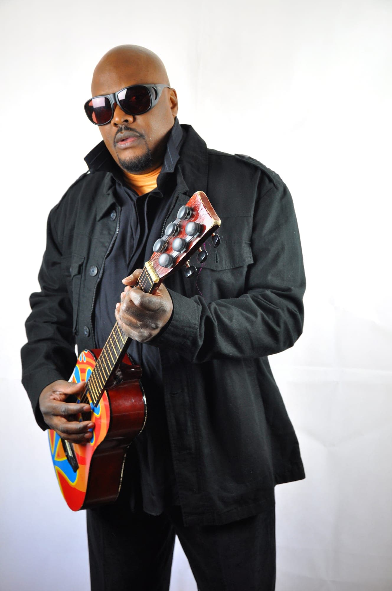 Studio portrait of a musician holding an electric guitar