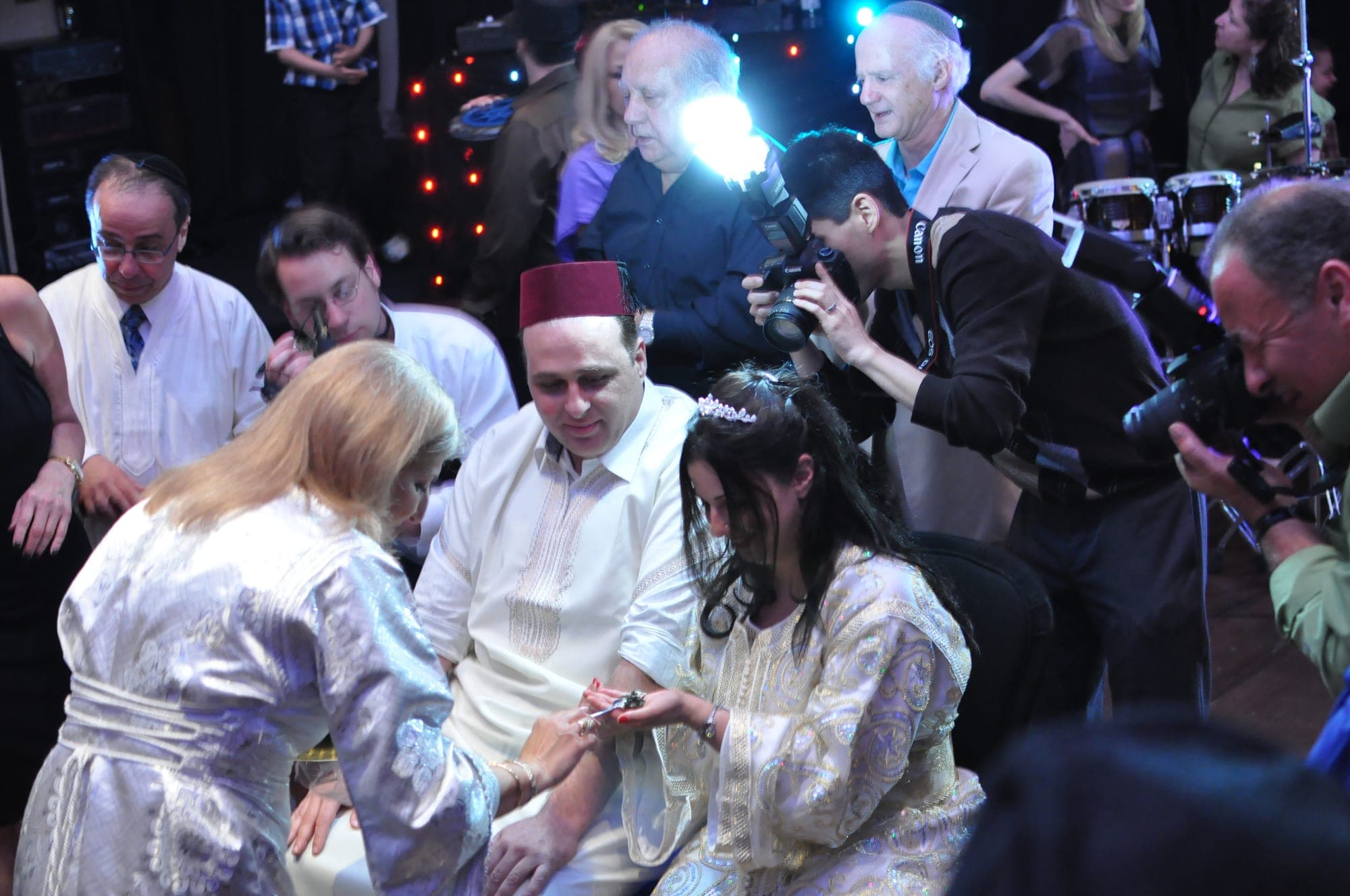 Photographers and guests crowding a ceremony moment