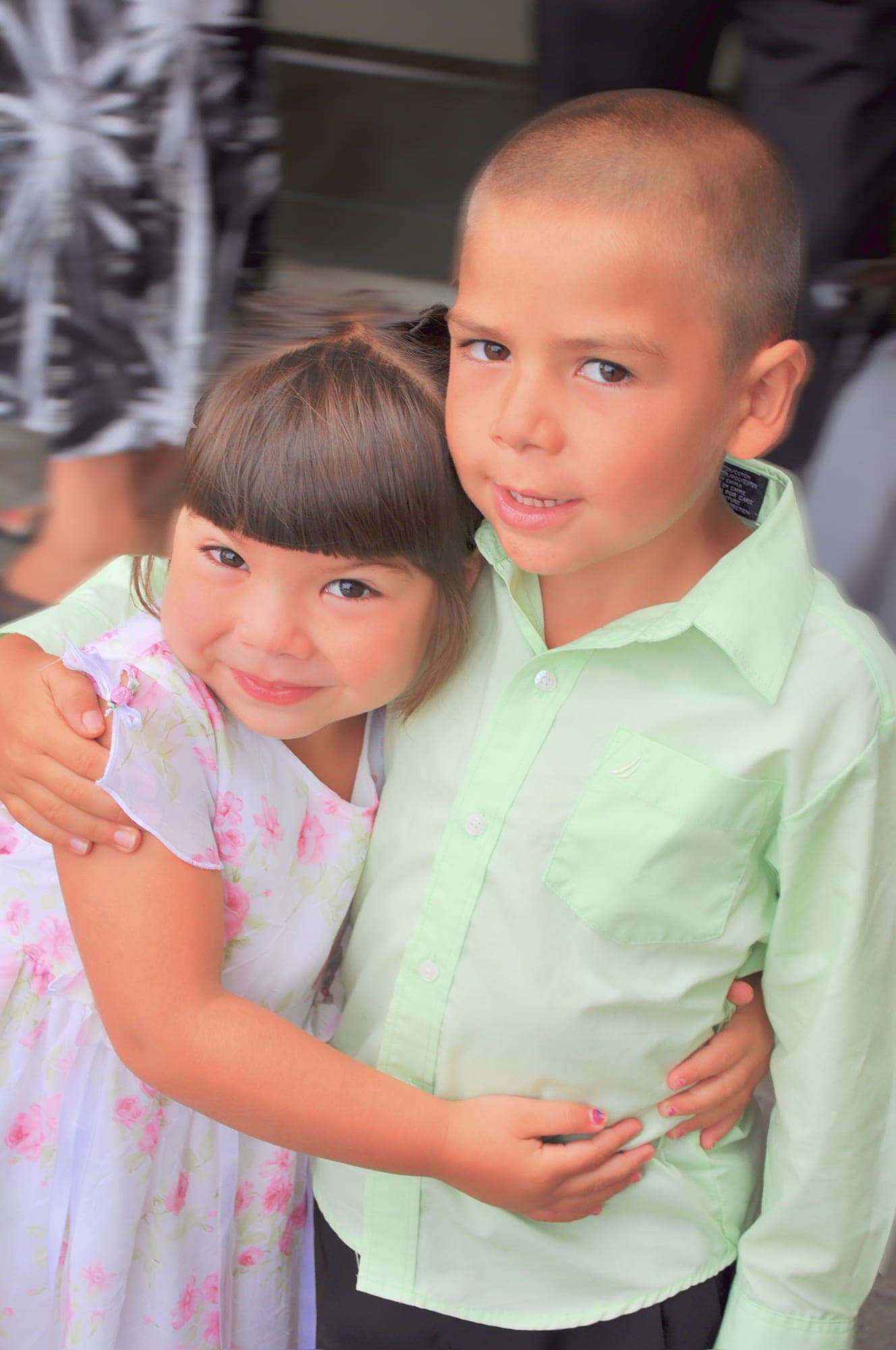 Two young children hugging each other
