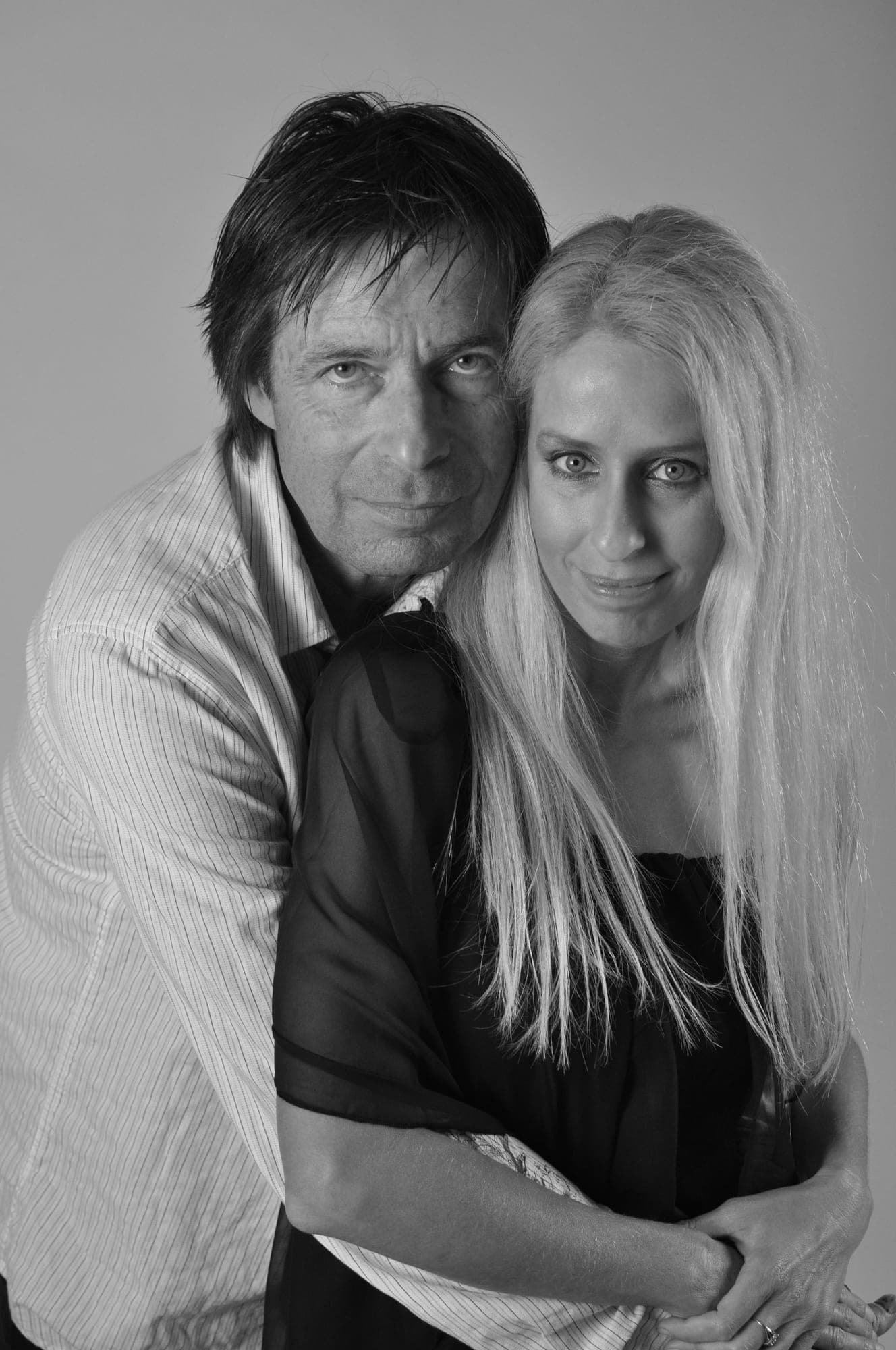 Black and white studio portrait of a couple embracing