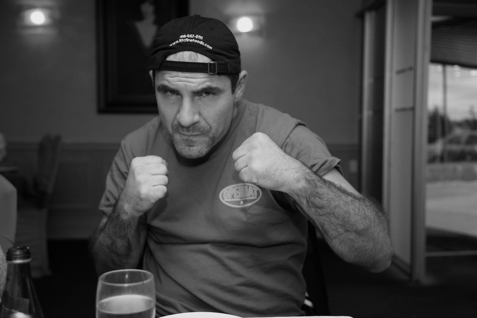 Black and white environmental portrait of a man in a diner