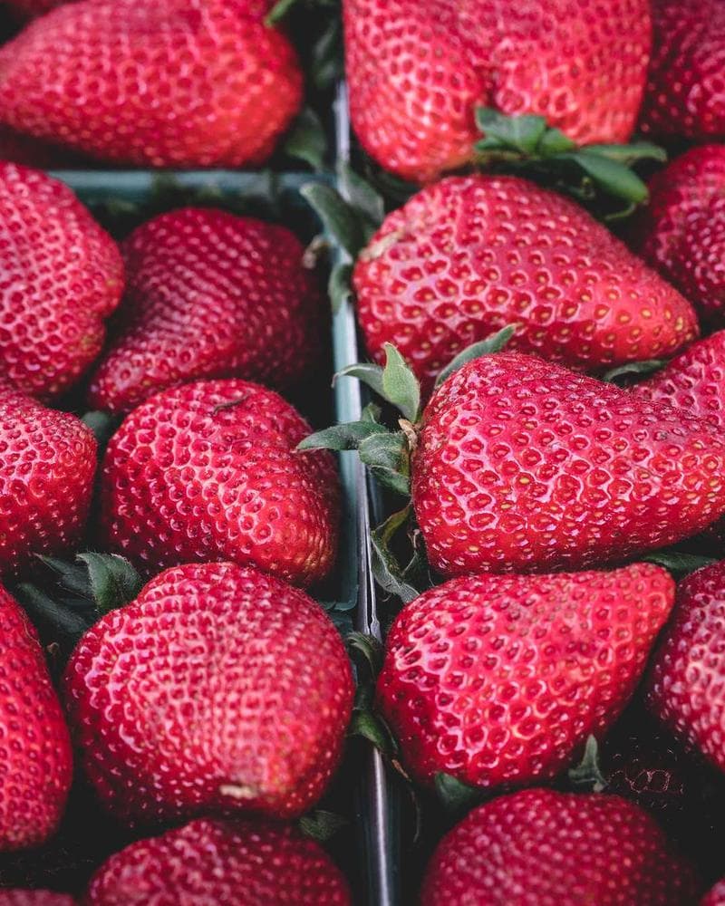 Colourful lifestyle product photography of fresh strawberries