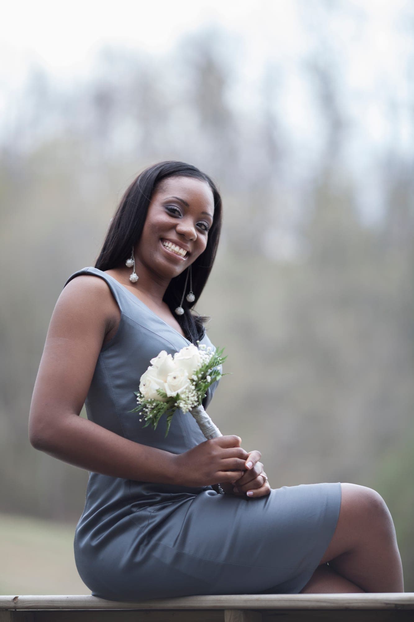 Bridesmaid in a periwinkle dress holding a white bouquet