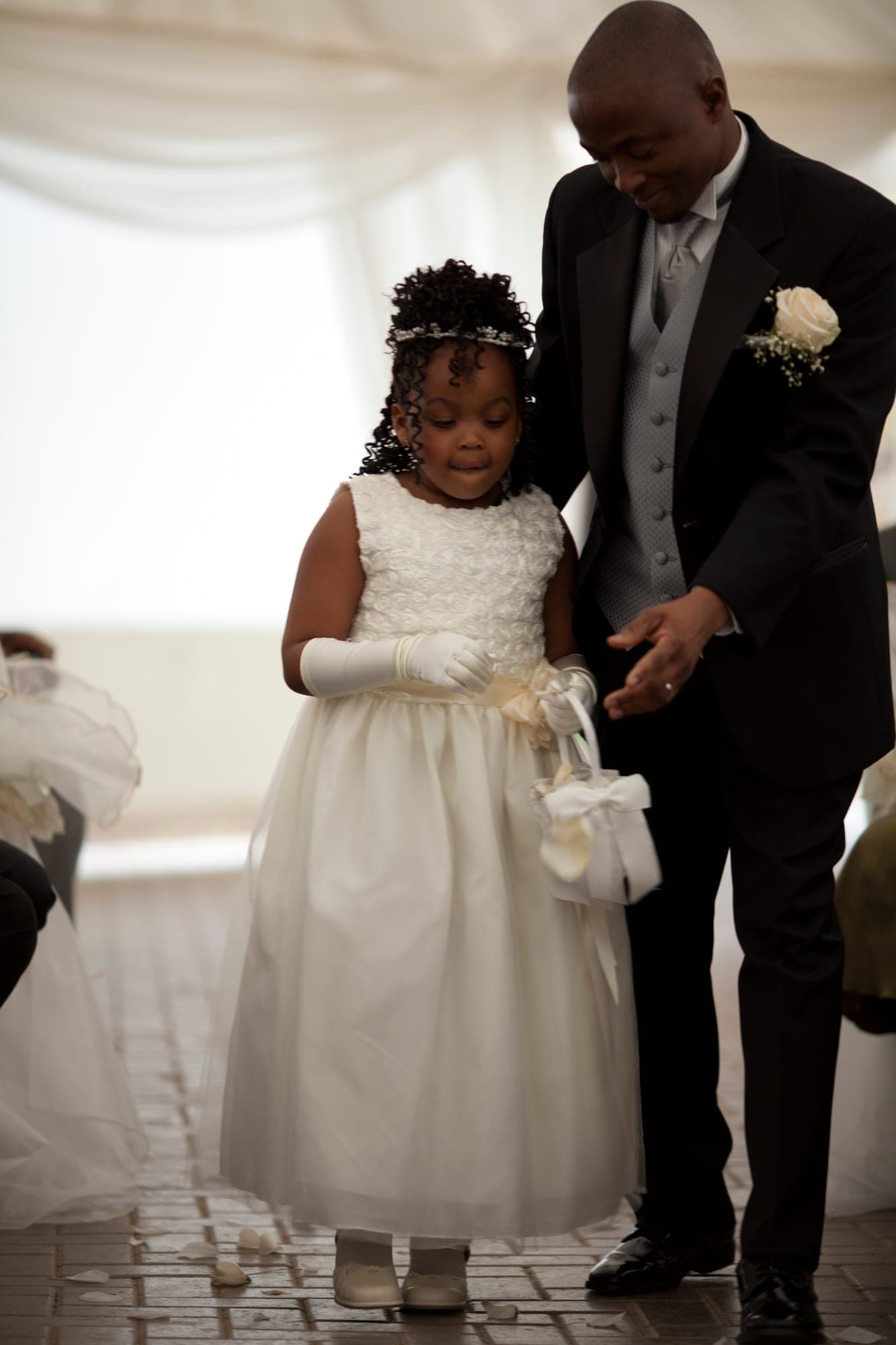 Father walking a flower girl down the aisle before the ceremony