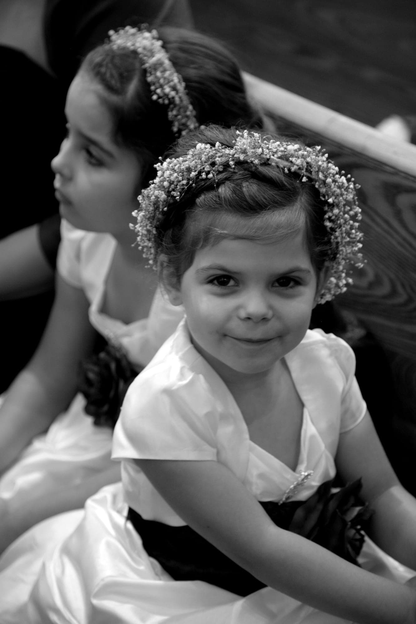 Black and white portrait of a flower girl wearing a beaded tiara