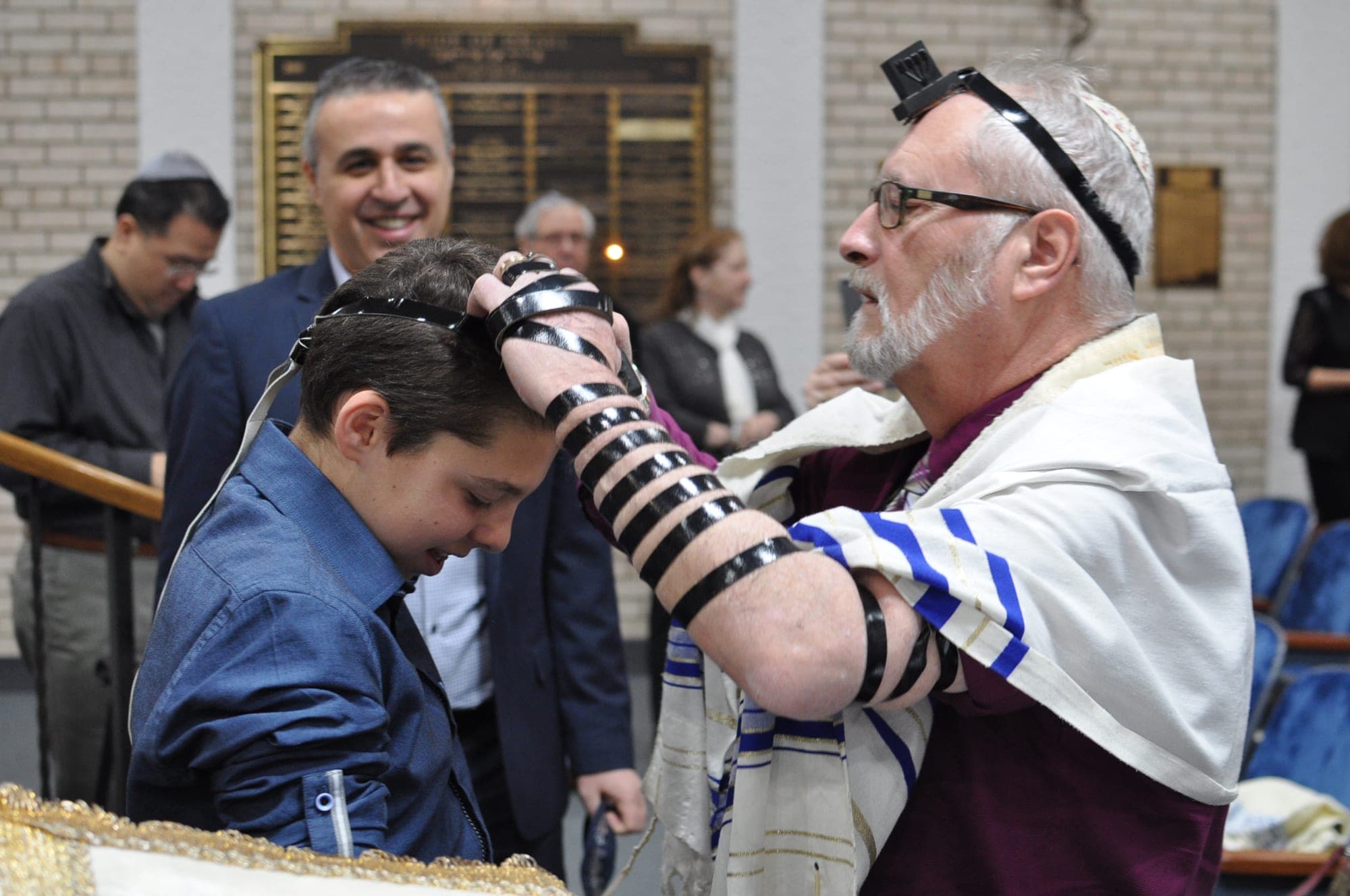 Bar mitzvah boy receiving a blessing while wearing tefillin