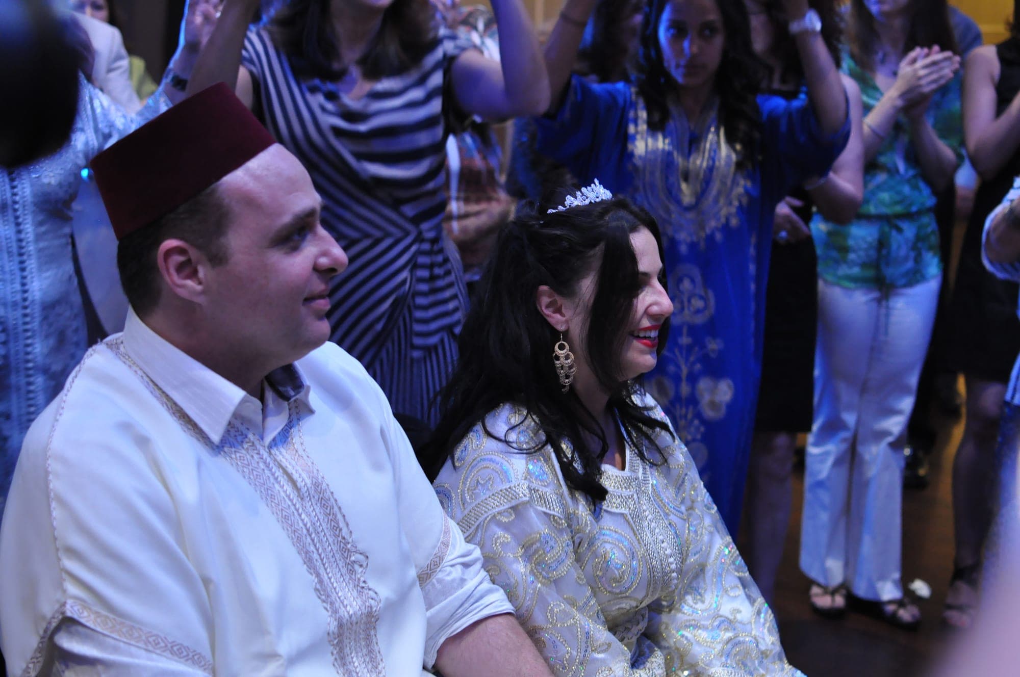 Guests dancing in white and silver at a henna celebration