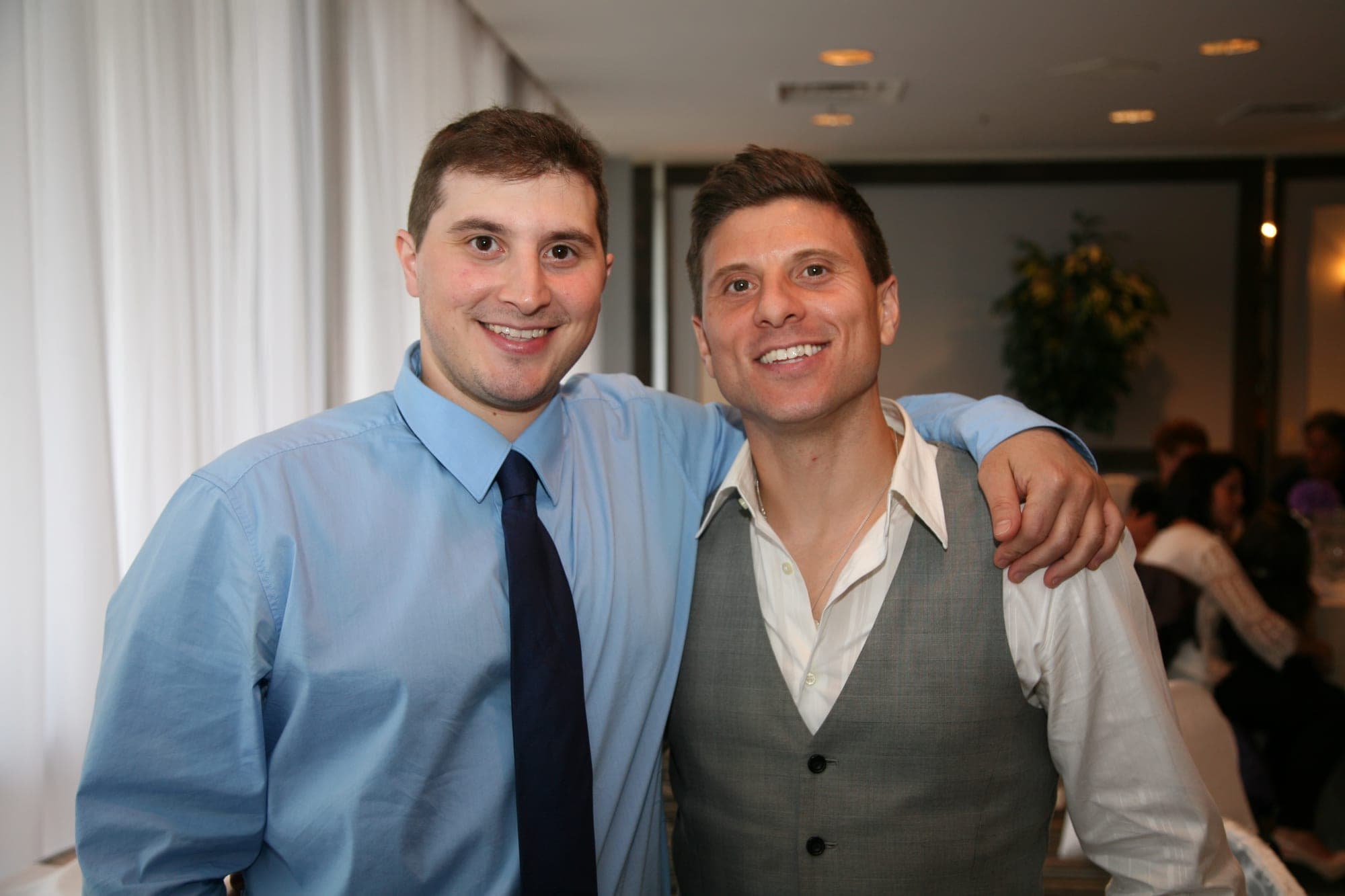 Two friends photographed at an evening reception