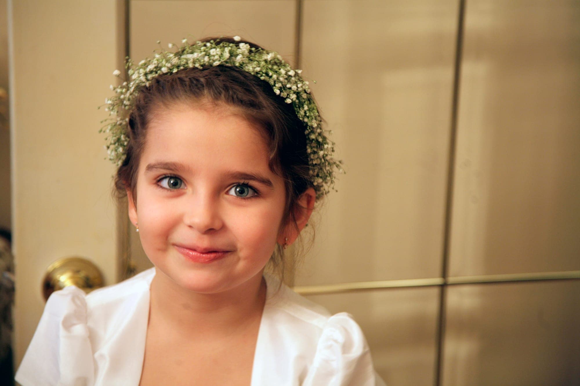 Portrait of a young girl in a baby's breath crown in warm golden light